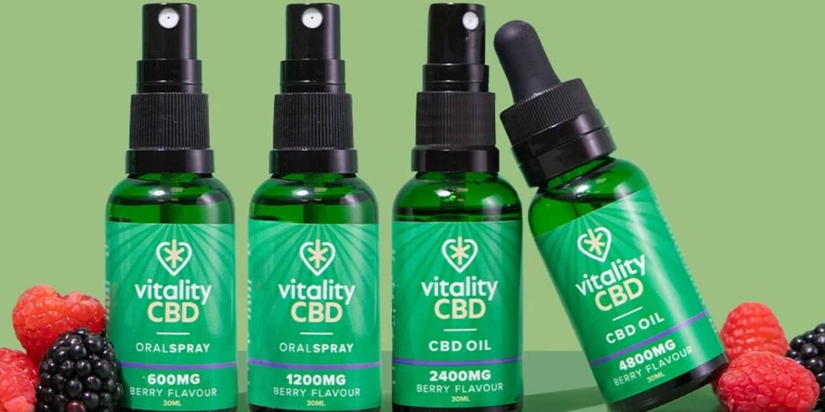 Vitality CBD Oils lined up side by side berries and green background