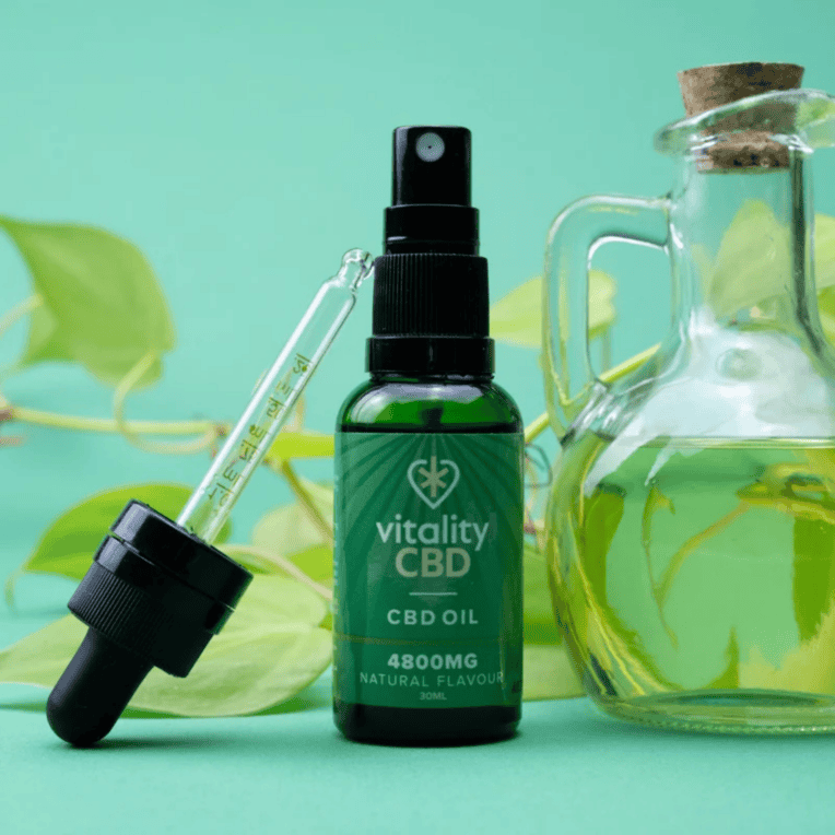 Vitality CBD Oil 4800mg natural with jar of oil and pipette leafy background