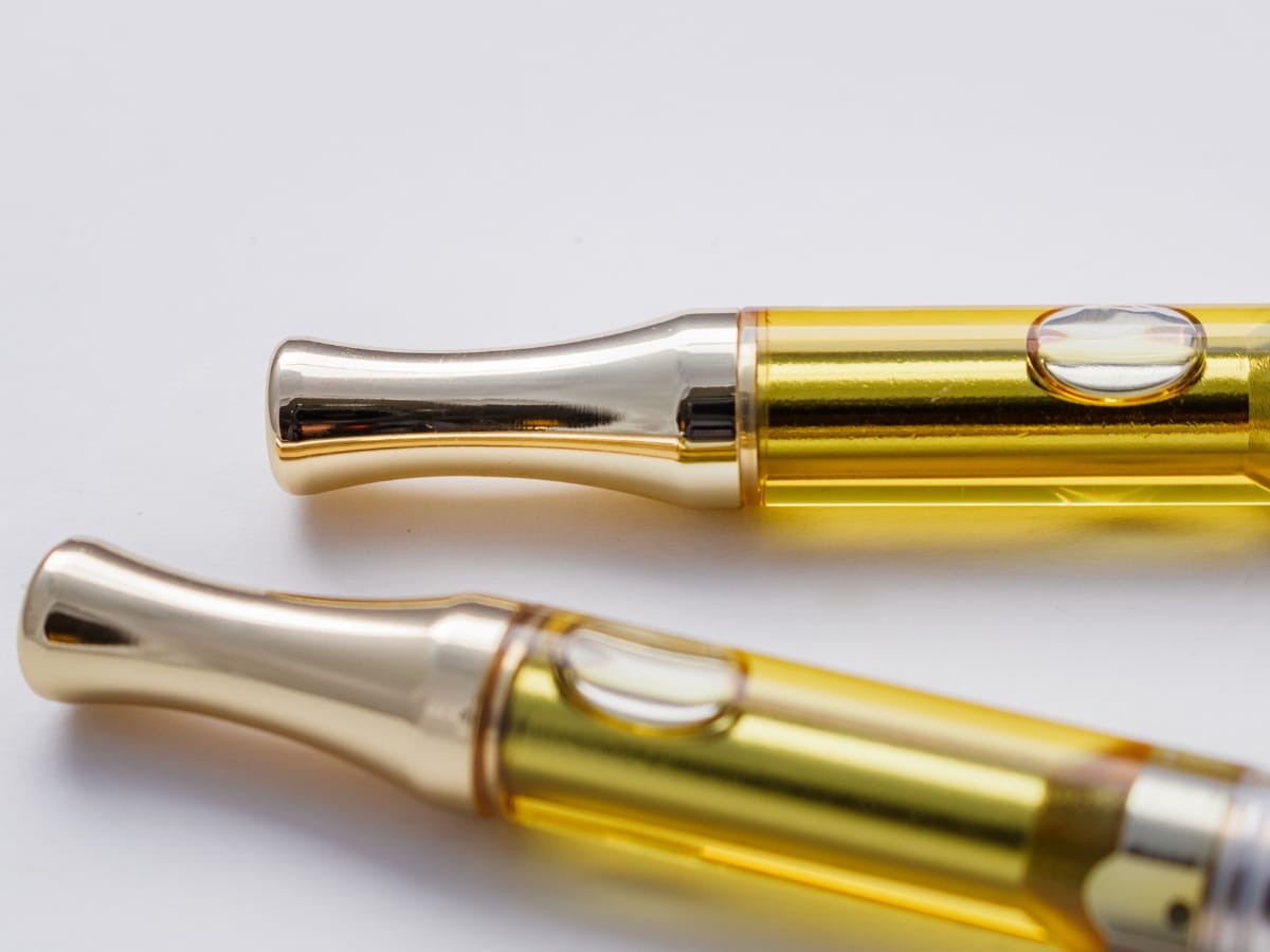 Two CBD Distillate Carts lying on a white background