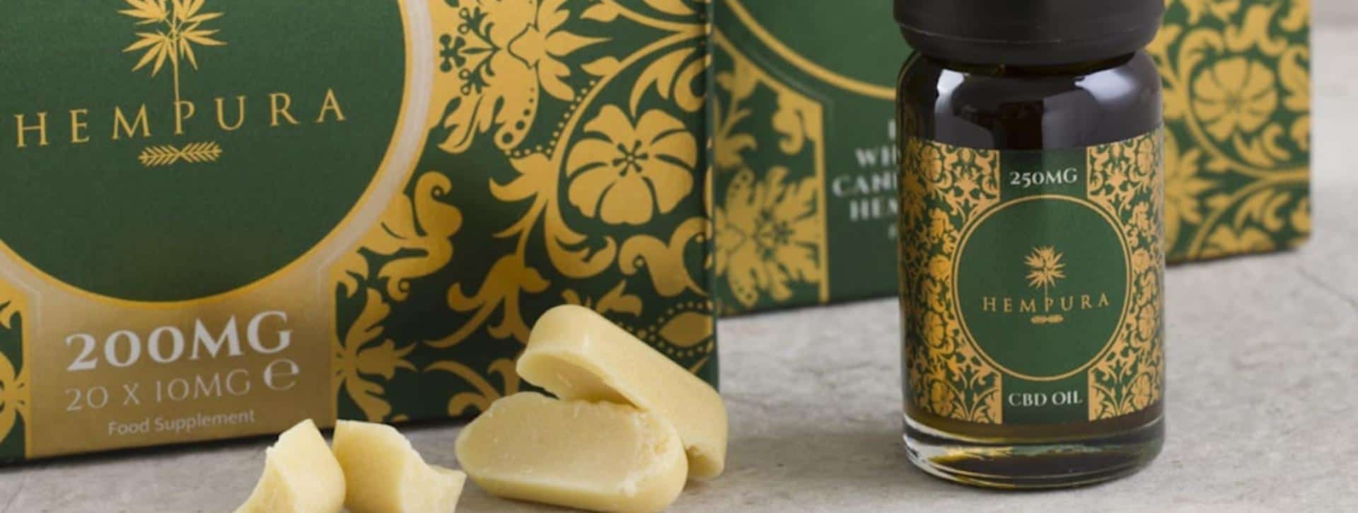 Hempura CBD capsules and CBD oil boxes with white CBD chocolate