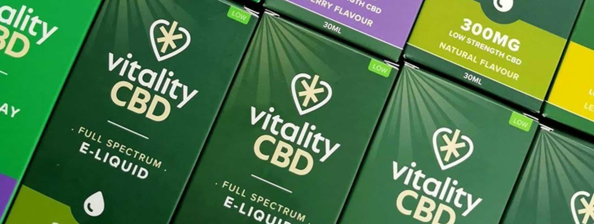 Vitality CBD oils and e-liquid side by side lying down