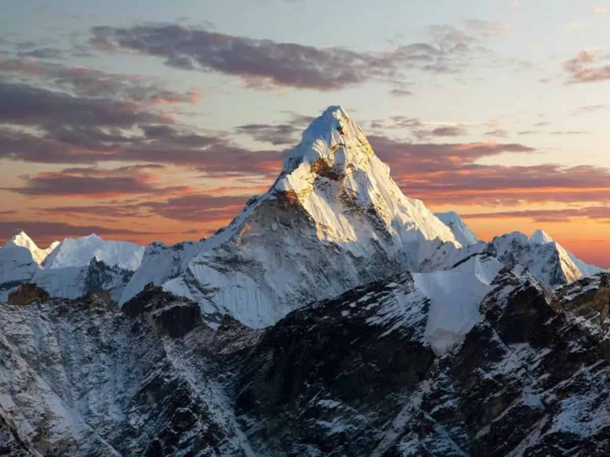 Himalayan mountains with a red and blue sky behind