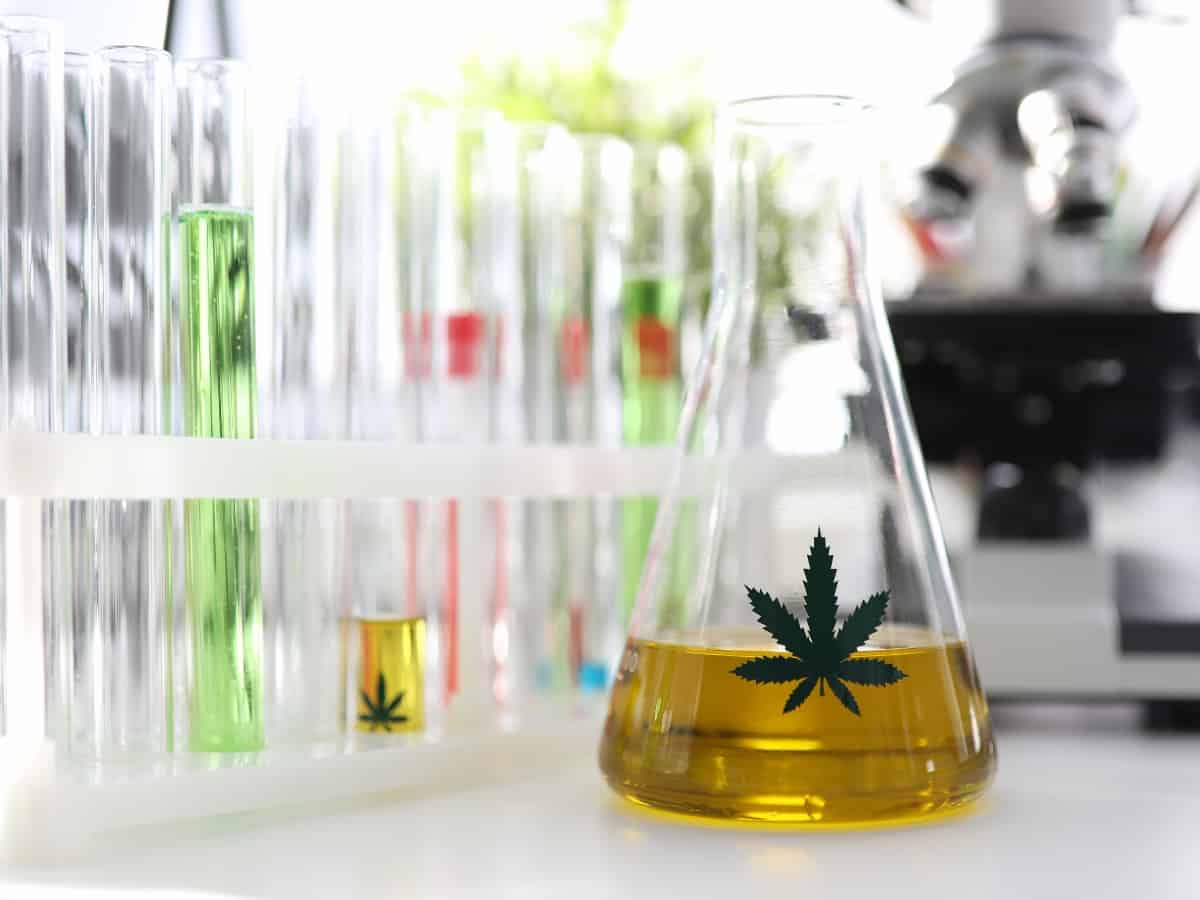 Cylinder of CBD extract in a lab testing environment