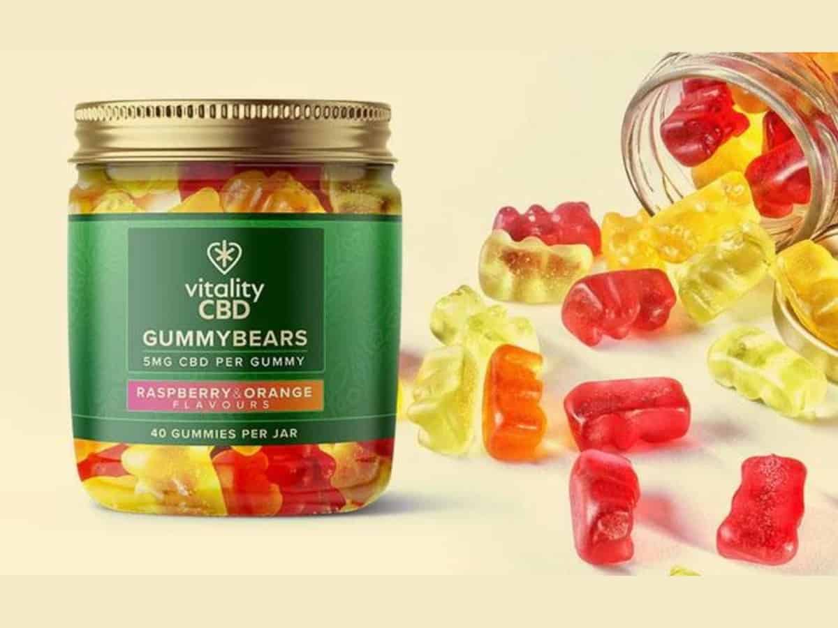 Vitality CBD gummies pot with gummies spilled all over table