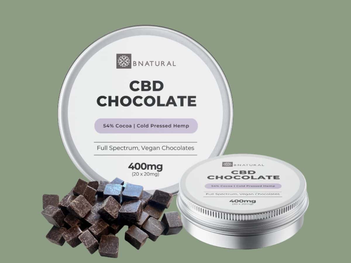 BNatural Cold pressed CBD Chocolate tin with chocolates green background