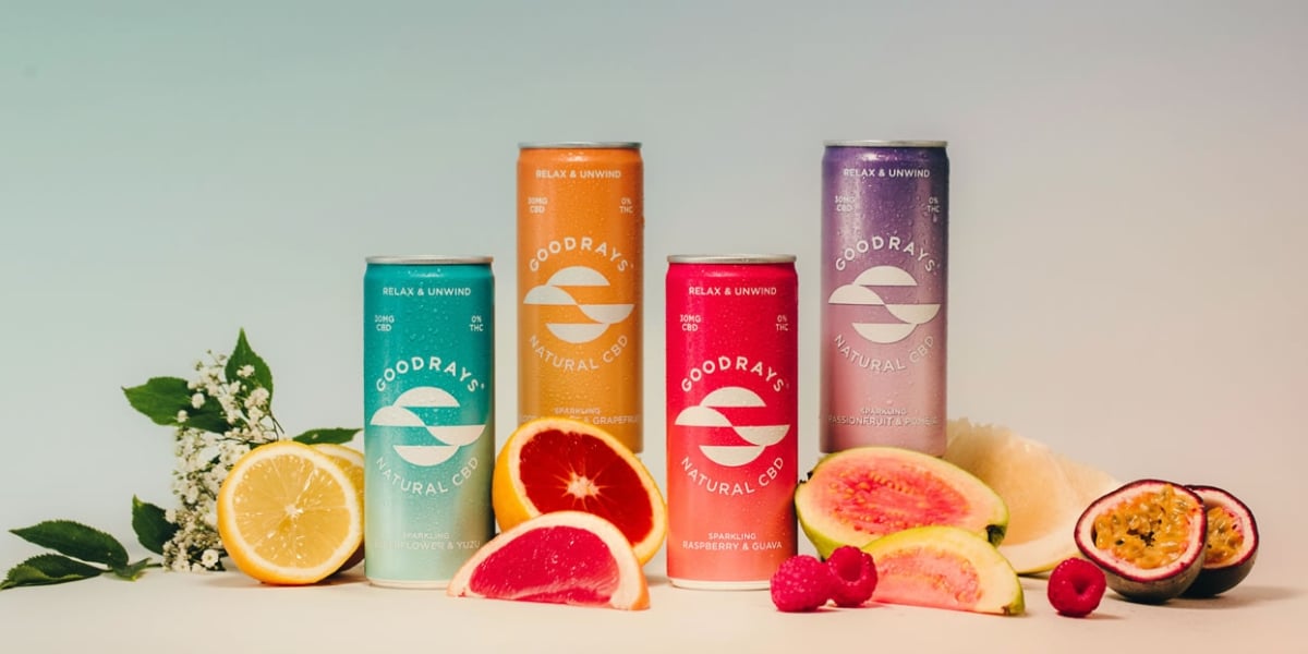 all goodrays flavour options lined up against an ombre background surrounded by juicy fruit