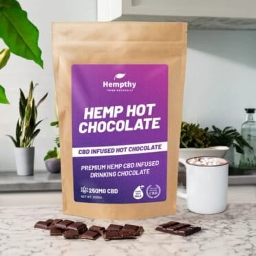 Hempthy CBD Hot Chocolate on kitchen table with chocolate and cup