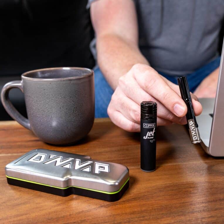 Dynavap G3 device lighter packaging and cup on table