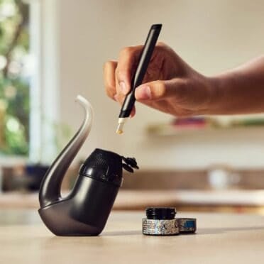 Loading the Puffco Proxy 2025 with wax while sitting on a kitchen table