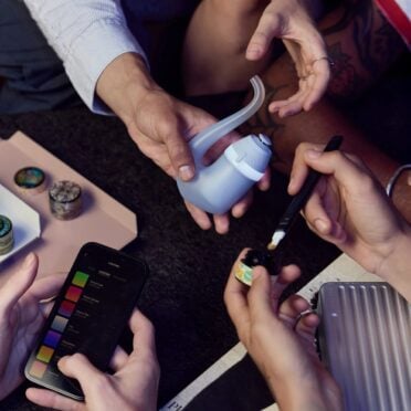 Sharing the Puffco Proxy 2025 with app among friends table background with device and app and multiple people's hands grinder on table
