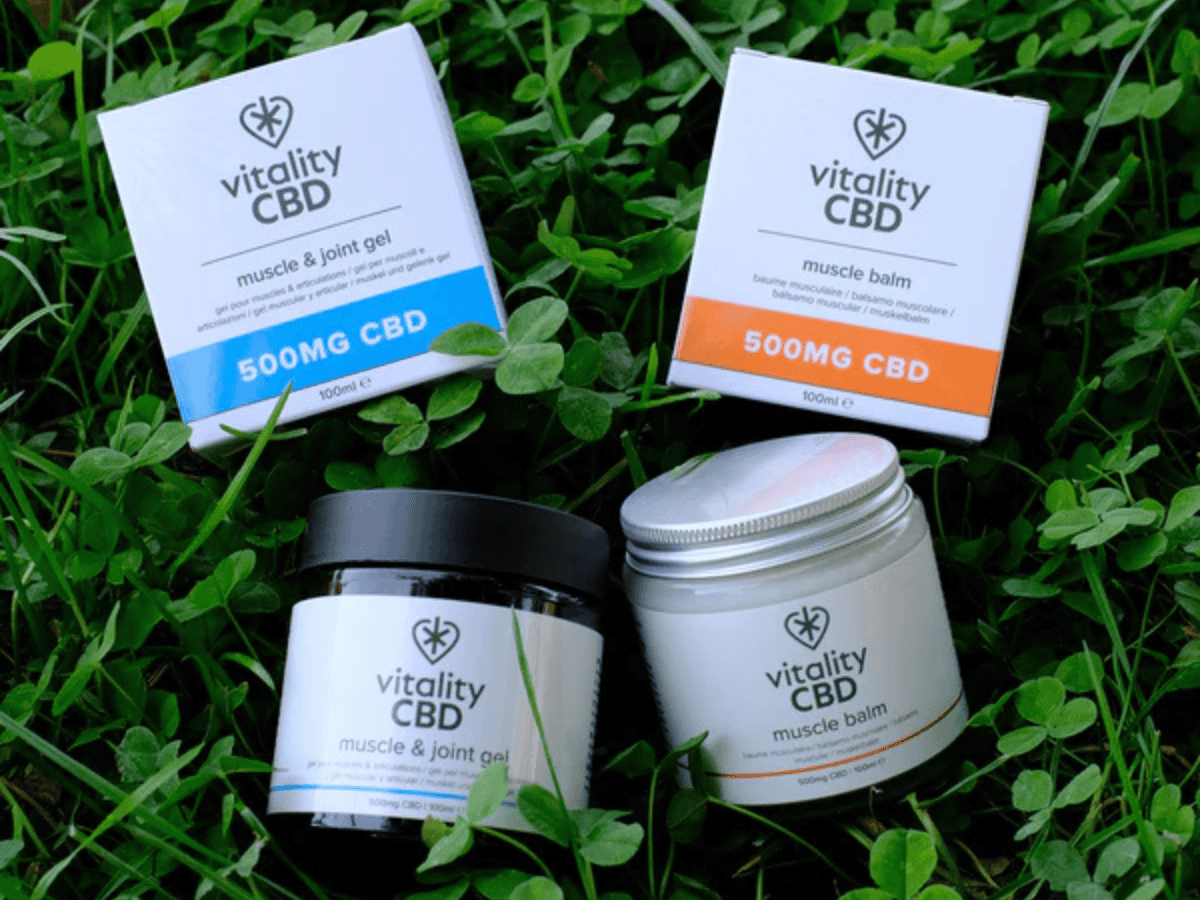 Vitality CBD Muscle Balm and Muscle and joint gel with both box and jar on a leafy surface