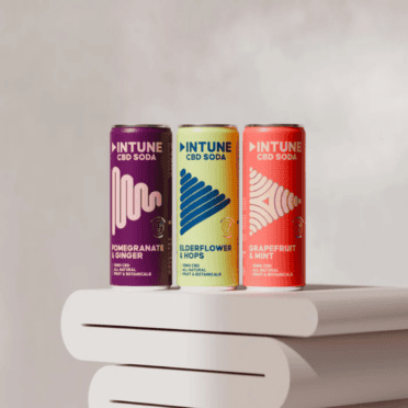 INTUNE CBD Drinks lined up on grey swirly table